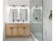 Modern bathroom with a double vanity, marble countertops, and a glass-enclosed walk-in shower at 1249 Ladd Sw St, Atlanta, GA 30310