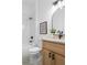 A modern bathroom featuring a black faucet, updated mirror, and bathtub/shower combination at 1249 Ladd Sw St, Atlanta, GA 30310