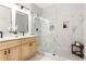 Bright bathroom featuring sleek vanity, glass enclosed shower with decorative tile and marble accents at 1249 Ladd Sw St, Atlanta, GA 30310