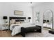 Bright bedroom featuring a plush bed with stylish pillows, modern art, and a large arched mirror at 1249 Ladd Sw St, Atlanta, GA 30310