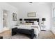 A relaxing bedroom with a plush bed, soft rug, and a door leading to a spa-like bathroom at 1249 Ladd Sw St, Atlanta, GA 30310