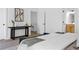 Cozy bedroom showcasing a modern console table, neutral decor, and a glimpse of the staircase at 1249 Ladd Sw St, Atlanta, GA 30310