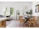 Bright dining area with many windows, wood floors, a round table, and access to the living room at 1249 Ladd Sw St, Atlanta, GA 30310
