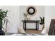 Tastefully decorated entryway with a round accent mirror, modern table, and elegant decor at 1249 Ladd Sw St, Atlanta, GA 30310