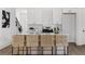 Bright, open kitchen featuring a large island with bar stools, white cabinets, and modern appliances at 1249 Ladd Sw St, Atlanta, GA 30310