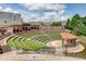 A scenic outdoor amphitheater with tiered seating, a stage, and lush landscaping at 1260 Ainsworth Aly # 47, Sugar Hill, GA 30518