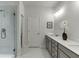 Beautiful en-suite bathroom features double vanity, framed mirror and glass enclosed shower at 1260 Ainsworth Aly # 47, Sugar Hill, GA 30518