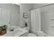 Well-lit bathroom features a shower-tub combination and modern vanity with decorative accents at 1260 Ainsworth Aly # 47, Sugar Hill, GA 30518