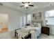 This well-appointed primary bedroom features ceiling fan, bright windows and neutral palette at 1260 Ainsworth Aly # 47, Sugar Hill, GA 30518