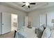 Spacious primary bedroom with en-suite bathroom features carpet, tray ceilings and windows at 1260 Ainsworth Aly # 47, Sugar Hill, GA 30518