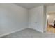An inviting bedroom with neutral walls, carpeted floors, and a view of an adjacent room at 1260 Ainsworth Aly # 47, Sugar Hill, GA 30518