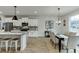 Dining area adjacent to the kitchen features a modern chandelier and a large window at 1260 Ainsworth Aly # 47, Sugar Hill, GA 30518