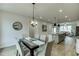 Dining room with view of kitchen and living room at 1260 Ainsworth Aly # 47, Sugar Hill, GA 30518