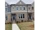 Charming townhome with gray brick, neutral siding, well maintained landscaping, and large windows at 1260 Ainsworth Aly # 47, Sugar Hill, GA 30518