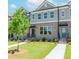 Attractive brick townhome with a tidy green lawn, concrete path, and welcoming front entrance at 1260 Ainsworth Aly # 47, Sugar Hill, GA 30518