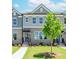 Inviting townhome with brick facade, neat landscaping, and clear walkway under a sunny sky at 1260 Ainsworth Aly # 47, Sugar Hill, GA 30518