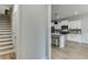 Modern kitchen with white cabinets, stainless steel appliances, pendant lighting, and wood floors at 1260 Ainsworth Aly # 47, Sugar Hill, GA 30518