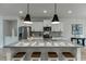 Granite kitchen island featuring stainless steel appliances and white cabinets with seating for four at 1260 Ainsworth Aly # 47, Sugar Hill, GA 30518