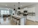 Modern kitchen featuring large island with seating open to the living room at 1260 Ainsworth Aly # 47, Sugar Hill, GA 30518