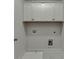 Bright laundry room with white cabinets, tile flooring, and modern washer hookups at 1260 Ainsworth Aly # 47, Sugar Hill, GA 30518