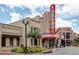 A vibrant shopping center featuring retail storefronts with unique architecture and landscaping at 1260 Ainsworth Aly # 47, Sugar Hill, GA 30518
