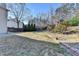 Large grassy backyard featuring a tiered landscape design, a gazebo, and mature trees with a wooden fence at 1824 Kristen Ct, Suwanee, GA 30024