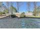 Large backyard with a stone pathway leading through the manicured landscape at 1824 Kristen Ct, Suwanee, GA 30024