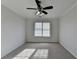 Bright bedroom with a ceiling fan and natural light coming from the window at 1824 Kristen Ct, Suwanee, GA 30024