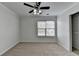 A bedroom featuring carpet flooring, ceiling fan, closet, and window at 1824 Kristen Ct, Suwanee, GA 30024