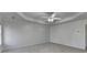 A spacious bedroom with one window, carpet flooring, and a ceiling fan at 1824 Kristen Ct, Suwanee, GA 30024