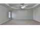 A spacious bedroom with one window, carpet flooring, and a ceiling fan at 1824 Kristen Ct, Suwanee, GA 30024