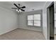 A bedroom featuring carpet flooring, ceiling fan, closet, and window at 1824 Kristen Ct, Suwanee, GA 30024