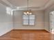 Bright dining room with hardwood floors, chandelier, and white wall paneling at 1824 Kristen Ct, Suwanee, GA 30024