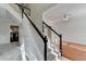 Welcoming entryway with staircase featuring black handrails, carpeted steps, and open access to the formal living room at 1824 Kristen Ct, Suwanee, GA 30024