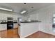 Kitchen with white cabinets, black countertops, hardwood floors and backyard access at 1824 Kristen Ct, Suwanee, GA 30024