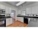 Kitchen featuring white cabinets and black countertops with stainless steel appliances at 1824 Kristen Ct, Suwanee, GA 30024