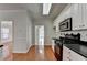 Corner view of the kitchen with black countertops and stainless steel appliances at 1824 Kristen Ct, Suwanee, GA 30024