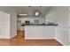 Kitchen with white cabinets and black countertops featuring a breakfast bar at 1824 Kristen Ct, Suwanee, GA 30024