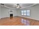 Spacious living room with decorative ceiling, hardwood floors, fireplace and large windows at 1824 Kristen Ct, Suwanee, GA 30024