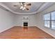 Cozy living room featuring a decorative ceiling, hardwood floors, and fireplace at 1824 Kristen Ct, Suwanee, GA 30024