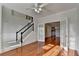 Beautifully lit living room with hardwood floors, double doors leading to the dining room, and an entryway staircase at 1824 Kristen Ct, Suwanee, GA 30024
