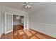 Bright living room featuring hardwood floors, a ceiling fan, and double doors that lead into another room at 1824 Kristen Ct, Suwanee, GA 30024