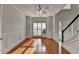 Inviting living room with hardwood floors, large windows, and a doorway that leads to an entryway staircase at 1824 Kristen Ct, Suwanee, GA 30024