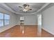 Spacious living room with hardwood floors, modern ceiling fan, and natural light at 1824 Kristen Ct, Suwanee, GA 30024