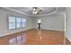 Expansive living room with hardwood floors, decorative ceilings, large windows, and a view to the kitchen at 1824 Kristen Ct, Suwanee, GA 30024