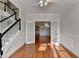 Well-lit living room with hardwood floors, a ceiling fan, and double doors that provide access to the dining room at 1824 Kristen Ct, Suwanee, GA 30024