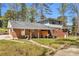 Charming brick home featuring a covered patio, ideal for relaxing and entertaining at 4444 Casco Nw Ln, Lilburn, GA 30047