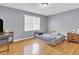 Bright bedroom features hardwood floors and natural light from a window at 4444 Casco Nw Ln, Lilburn, GA 30047
