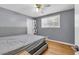 Neutral bedroom featuring hardwood floors, a ceiling fan, and a large window at 4444 Casco Nw Ln, Lilburn, GA 30047