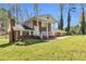 Charming brick home featuring a covered front porch, classic architecture, and lush front yard at 4444 Casco Nw Ln, Lilburn, GA 30047